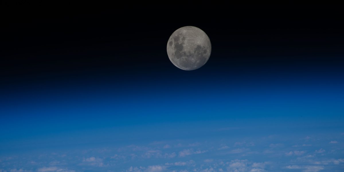 iss070e047294 (Dec. 26, 2023) -- The last full moon of 2023, the "Cold Moon," sits just above the blue glow of Earth's horizon as the International Space Station orbited nearly 270 miles over the Pacific Ocean.